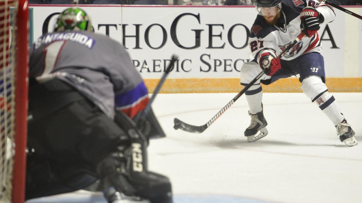 Macon Mayhem’s Dakota Klecha (27), right, shoots the puck with Knoxville Ice Bear’s Michael Santaguida (1) defending the goal in their game at the Macon Coliseum on Friday, Oct. 26.