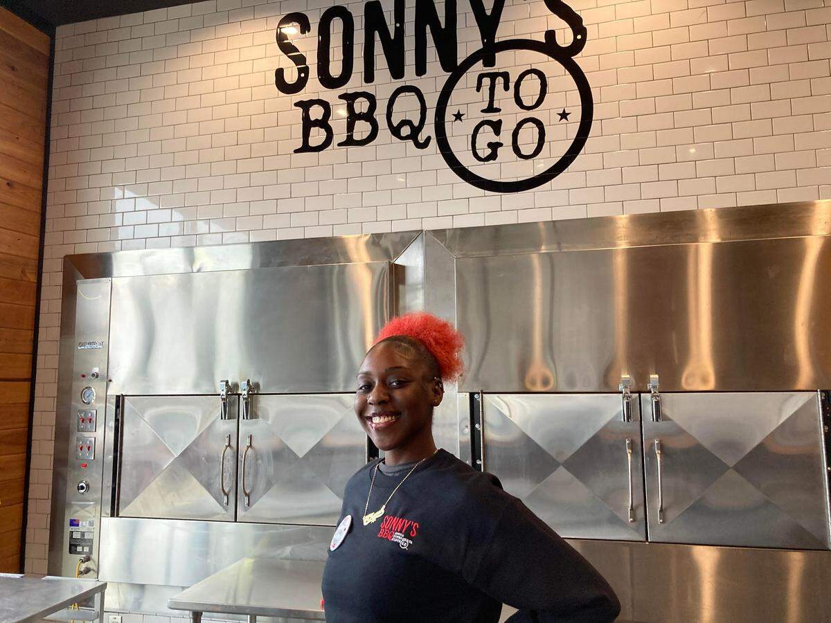 Akeyah Shannon mans the takeout station at the new Sonny’s BBQ at 5811 Zebulon Road in Macon.