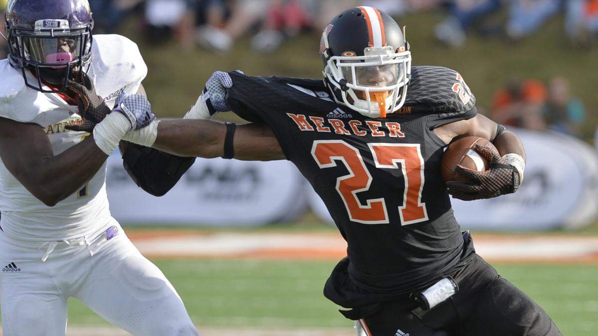 Mercer running back Alex Lakes (27) runs past Western Carolina’s Sertonuse Harris Jr. during their game last year.