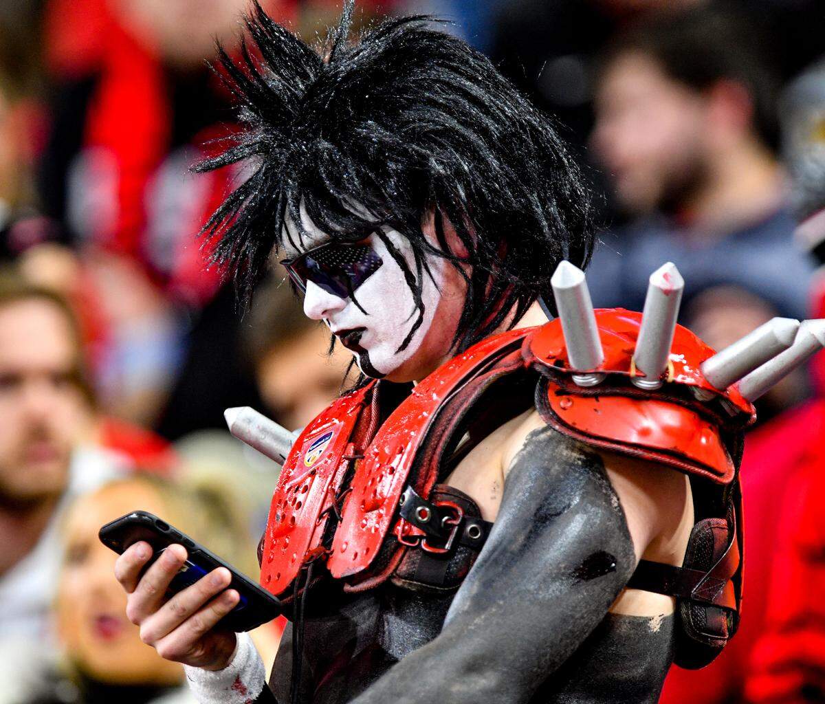 A Georgia fan looks at his phone prior to the Bulldogs’ College Football Playoff National Championship game against Alabama Monday night.