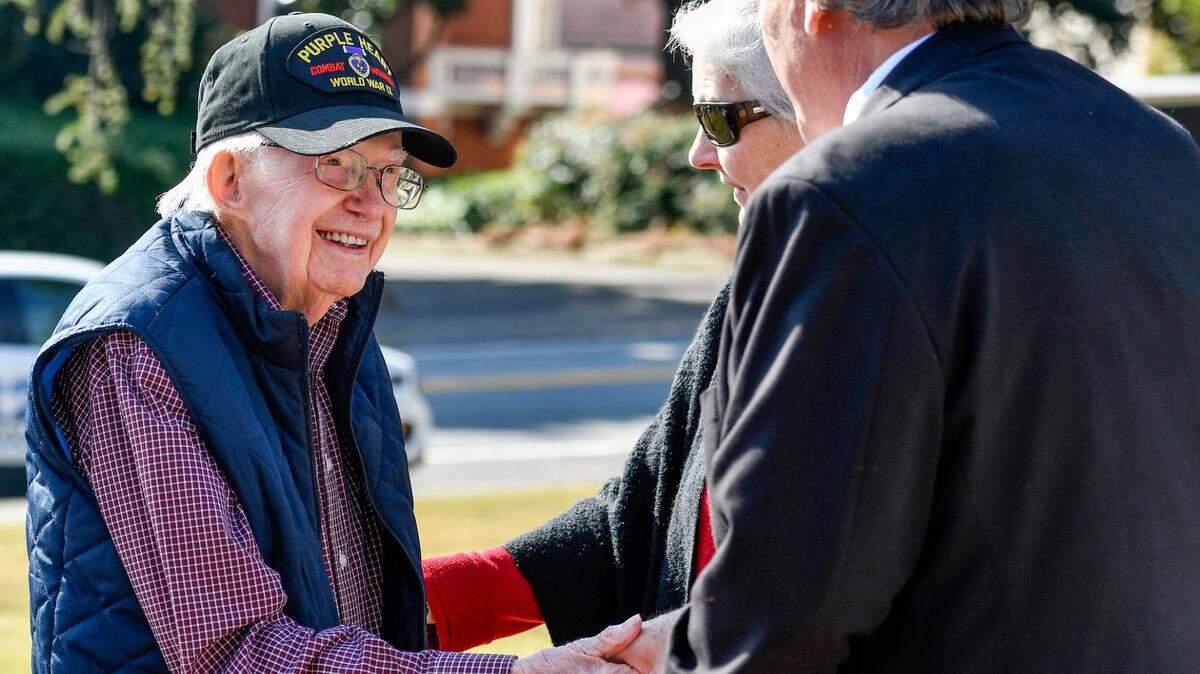 Middle Georgia State president Christopher Blake shakes hands World War II veteran Malcolm Land, 97, during a Veterans Day ceremony at Coleman Hill Thursday. Land was an U.S. Army medic and was awarded the Purple Heart and Combat Medic Badge.