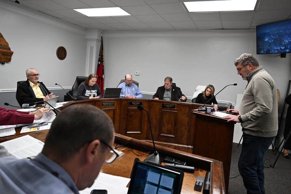 Development Authority of Jones County chair Erik Varnadoe, right, speaks to Jones County commissioners in favor of data centers during a meeting on Friday, Jan. 16, 2026, at the Jones County Government Center in Gray, Georgia. The board of commissioners unanimously passed a text amendment that would allow data centers with conditional use in the Griswoldville Industrial Park. 