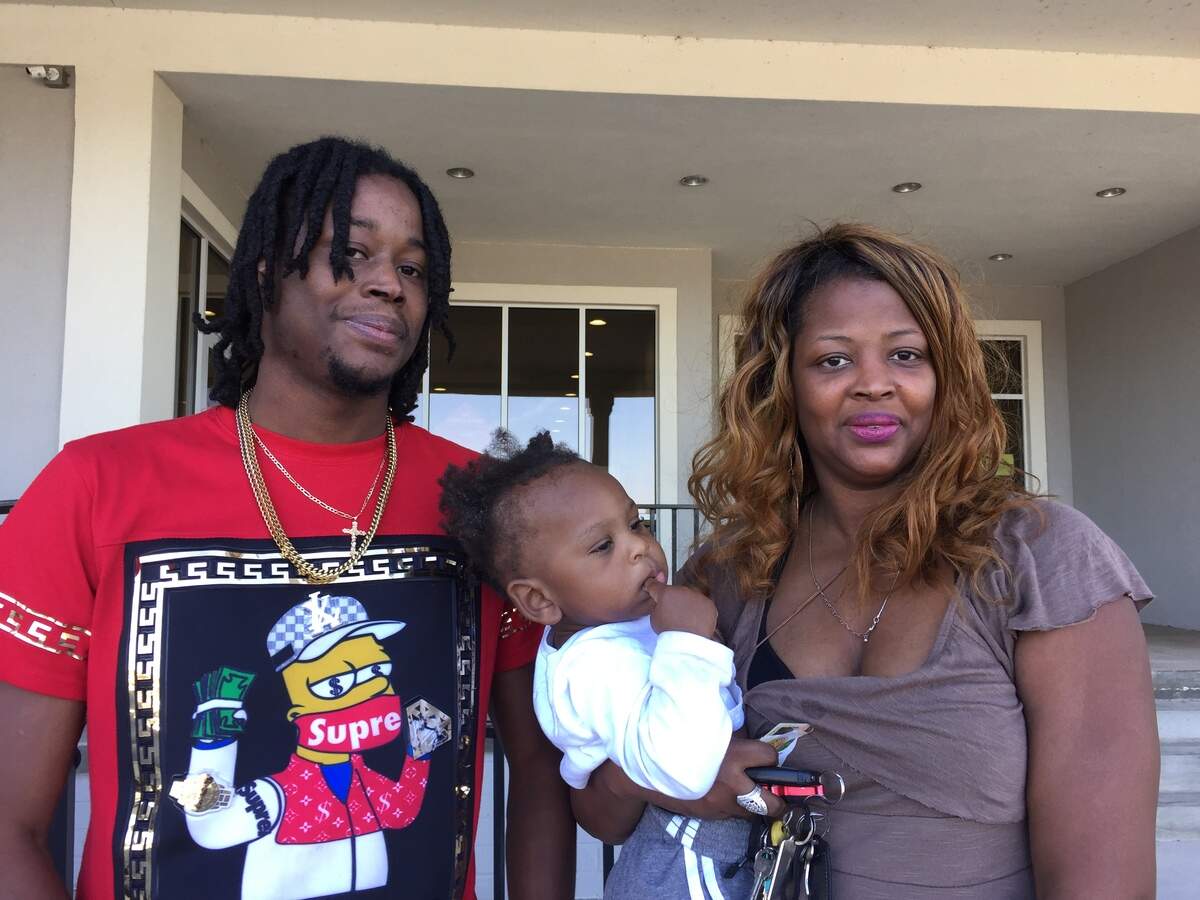 George Lee Gibson, left, and his mother Timiko Lamar, right, vote at the Dr. Robert J. Williams Complex At Ballard Hudson with Gibson’s one-year-old son, Lamar Jones.
