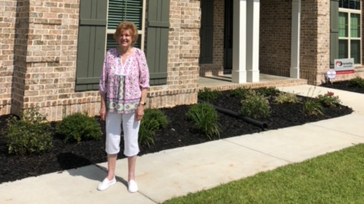Helen Tucker of Macon stands in front of the $400,000 Kathleen home she won in the Middle Georgia St. Jude Dream Home Giveaway.