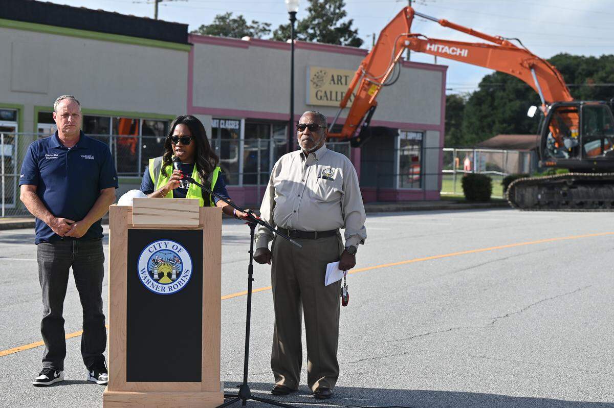 Warner Robins Mayor LaRhonda Patrick (middle) stands with Councilmen Charlie Bibb (left) and Clifford Holmes before a building demolition at Commercial Circle on Tuesday, Oct. 7, 2025, in Warner Robins, Georgia. The demolition was the largest yet in the city’s “Operation Reawaken” initiative.