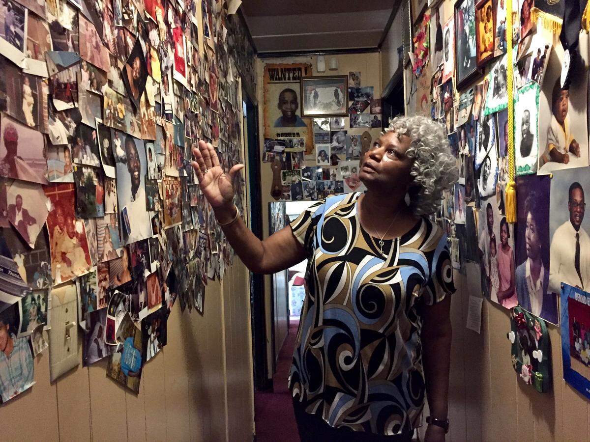 Hundreds of photos, notes and family mementos fill Theresa Hugley’s “Wall of Fame” in her house on Kings Park Circle. She feels a deep connection to the home, where she’s lived since 1985.