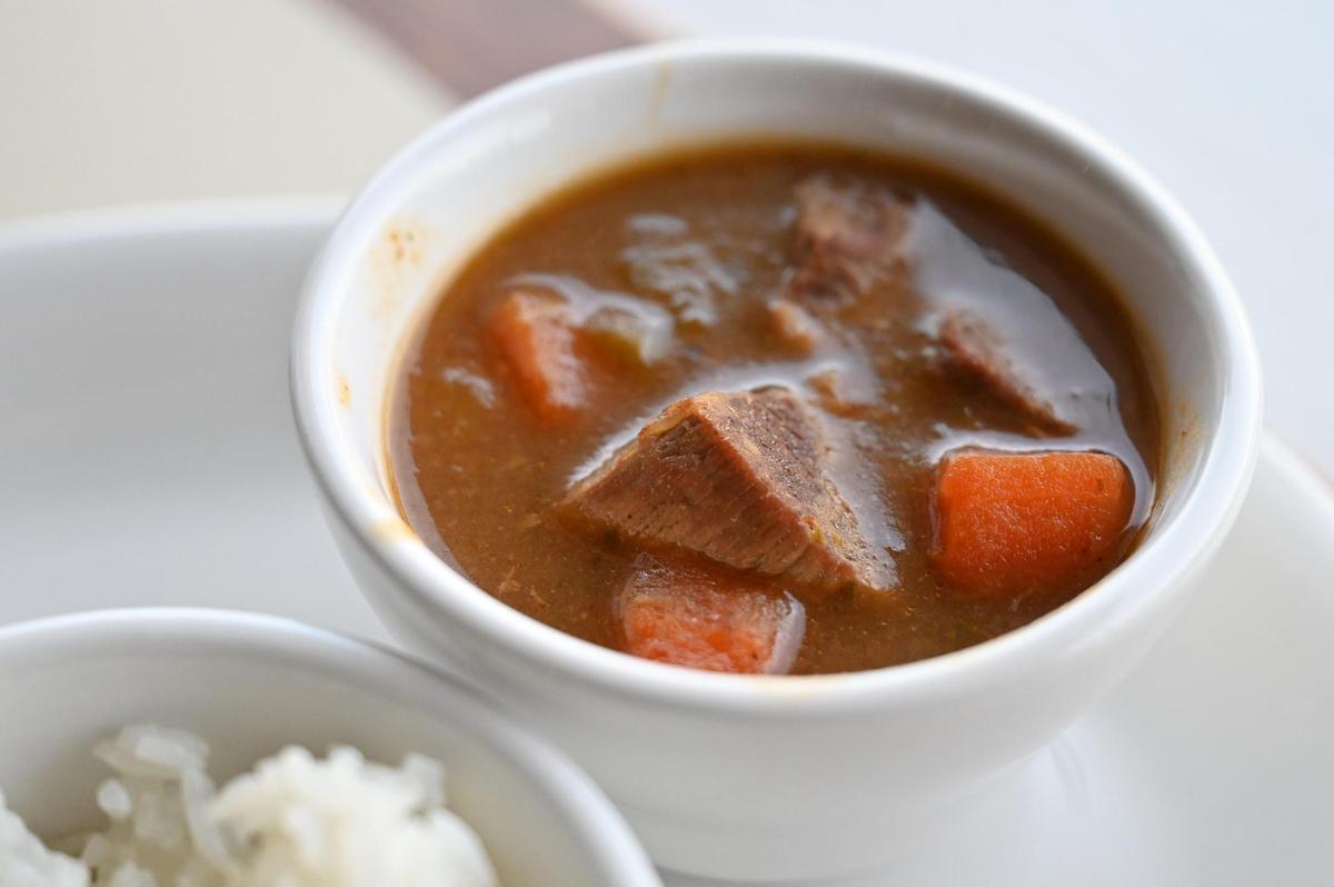 A sample of beef stew from Caribbean Queens Latin Cuisine sits on a table in the restaurant on Thursday, March 27, 2025, in Forsyth, Georgia. Owner Lisa Morales opened the Puerto Rican restaurant in downtown Forsyth in January.