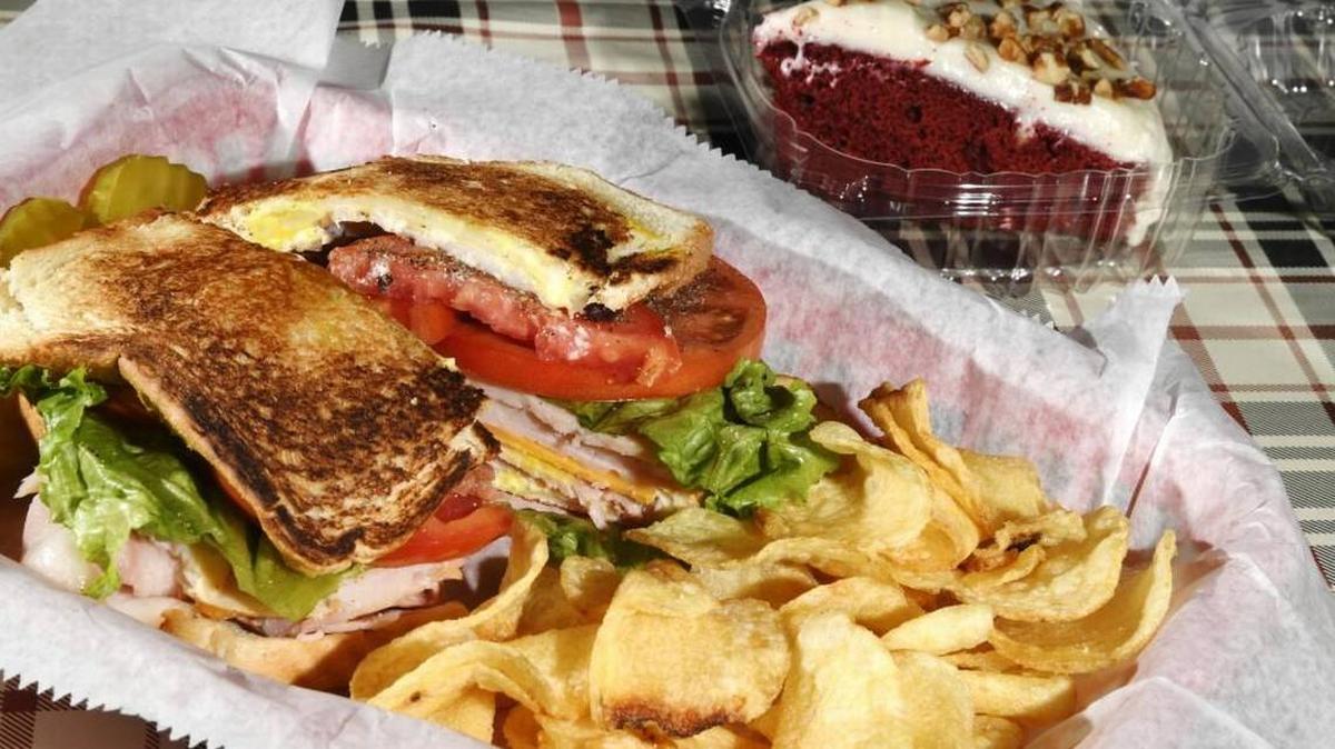 A club sandwich with chips and cake from Yoder’s Sandwich Shoppe in Perry.