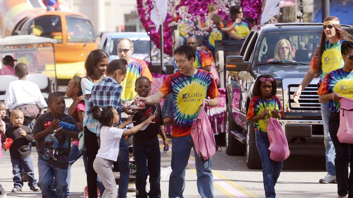 JASON VORHEES/THE TELEGRAPHChildren flock to parade participants handing out candy during a previous year's Cherry Blossom Festival Parade.
