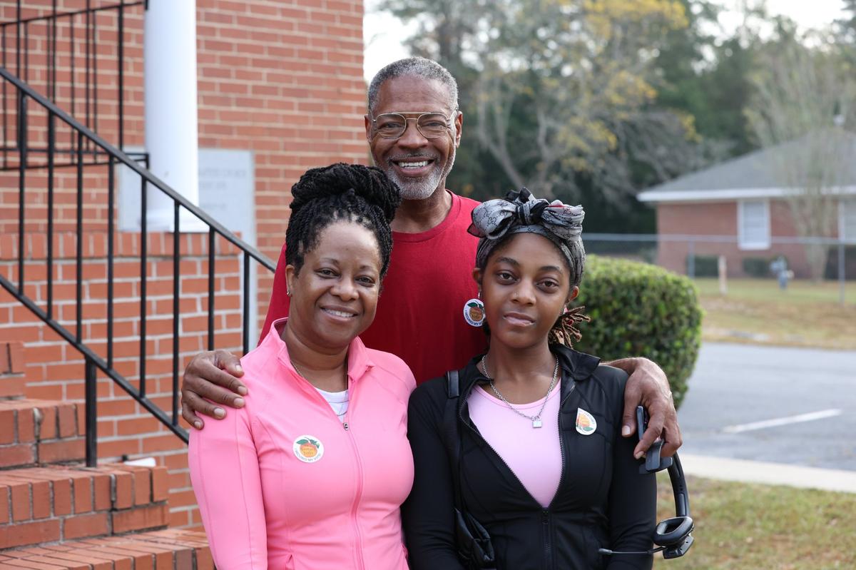From left to right: Michelle, Carwarnest and their daughter Jessica Cruse pose outside of New Griswoldville Baptist Church after voting on Election Day on Tuesday, Nov. 5, 2024, in Macon, Georgia. Jessica Cruse said that it was her first time voting and that she and her family voted for Republican candidates.