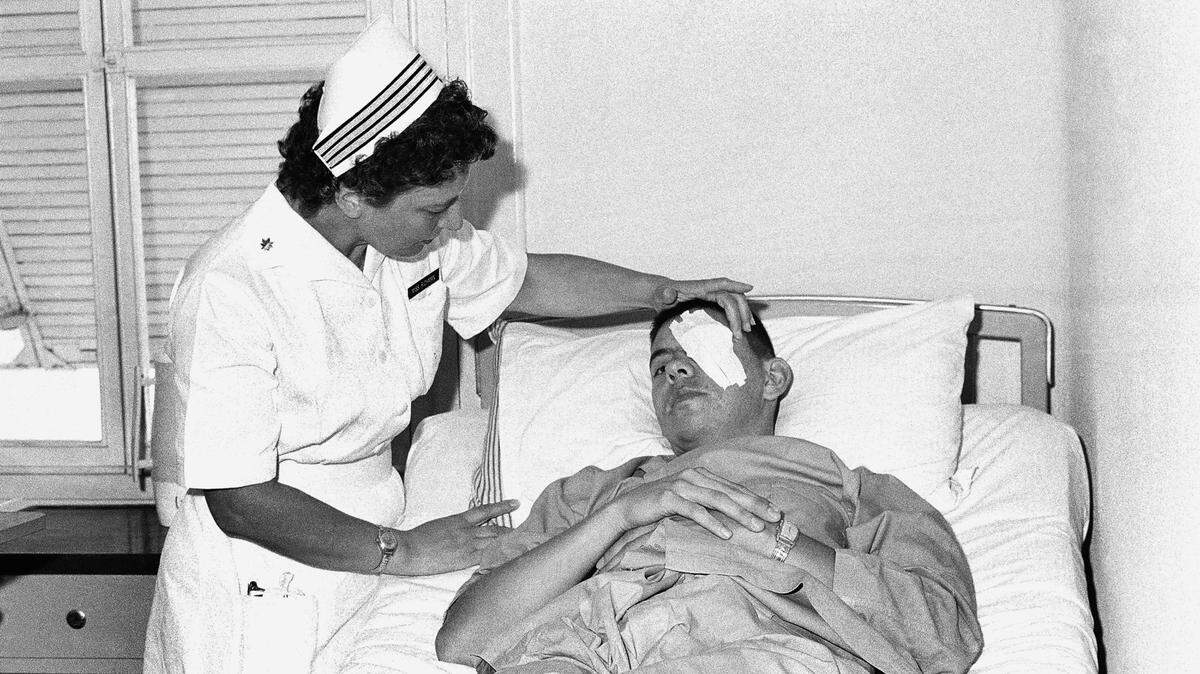 ASSOCIATED PRESSA nurse works on the eye of an wounded American soldier in Saigon in this 1964 file photo.
