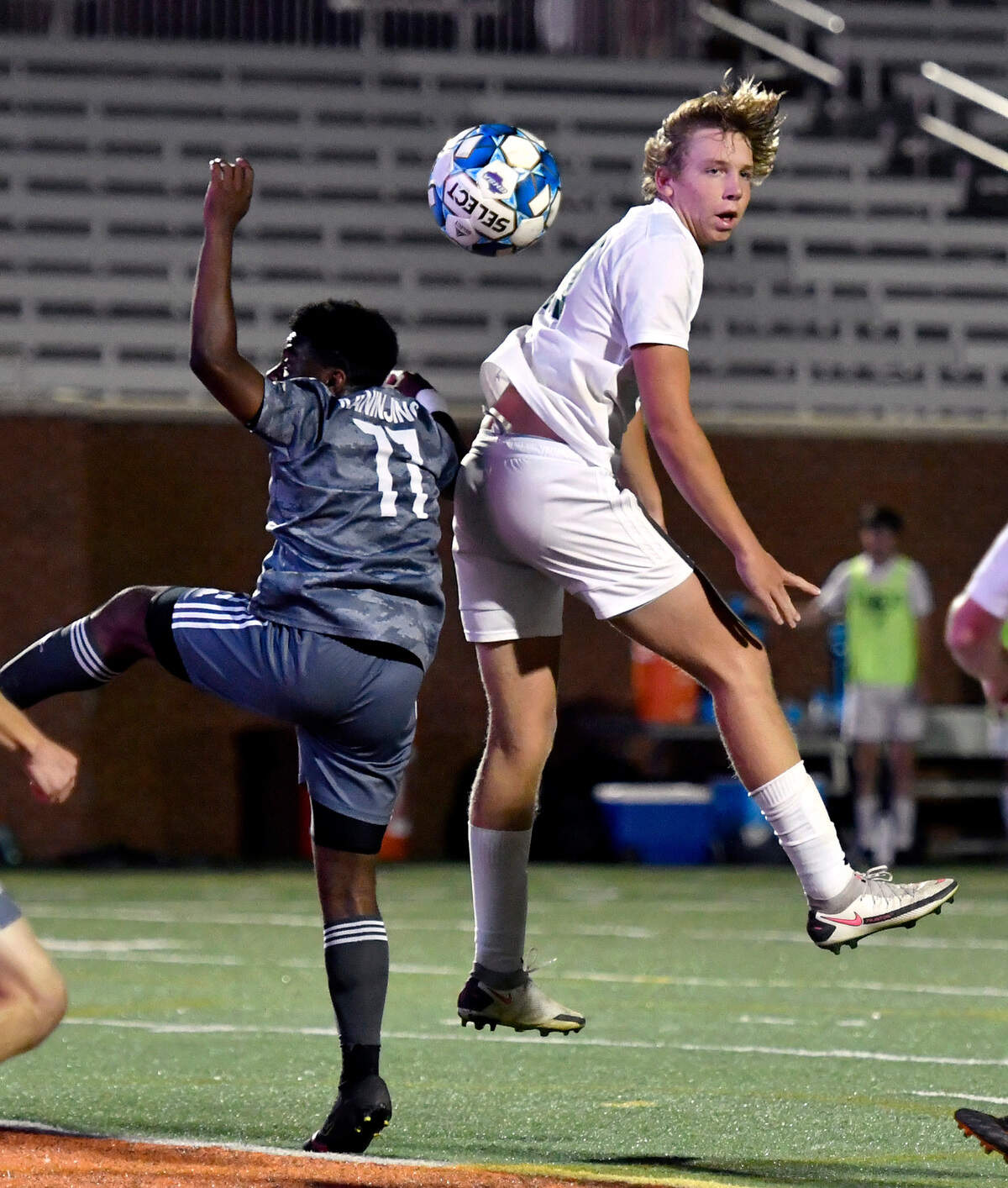 ACE defender Jake Prather (20) heads the ball towards goal over GMC left back Eden Kaninjing (11) during their GHSA 1A State Championship match Friday night at Mercer.