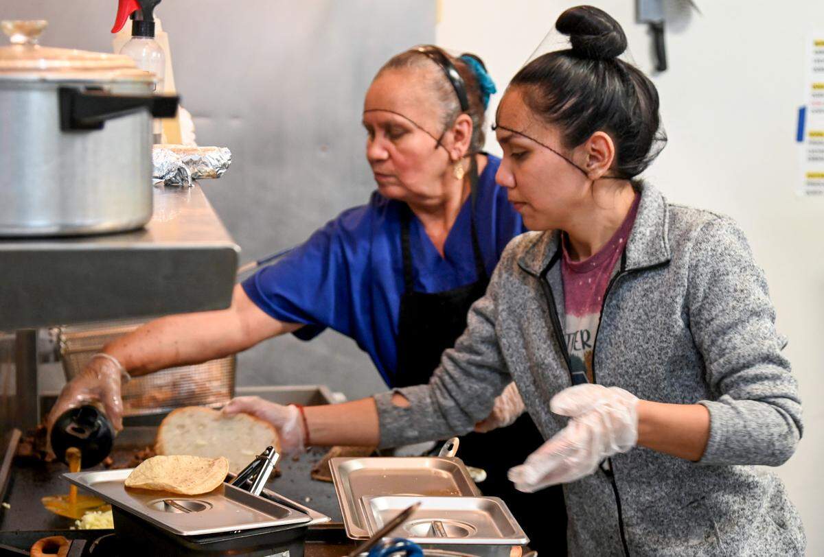 Brenda Torres prepares food in the kitchen with her mother Lorenza at El Sazon Homestyle Mexican Food in Macon.