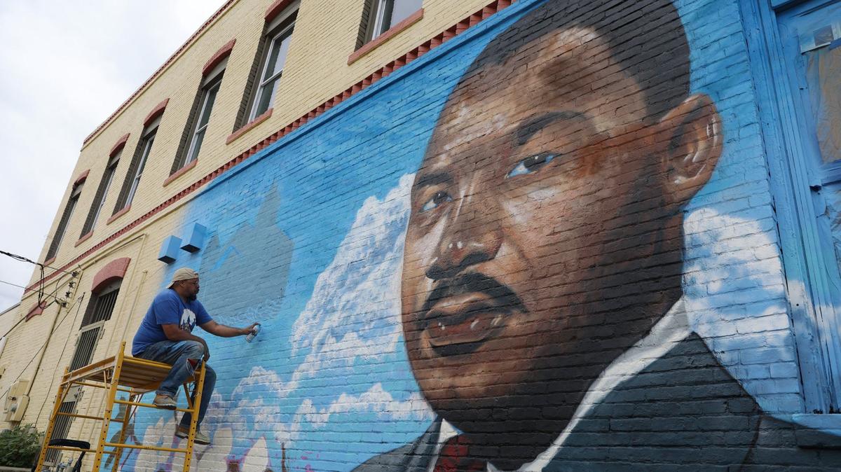Kevin “Scene” Lewis works on a mural of Rev. Martin Luther King Jr. on Wednesday, Sept. 11, 2024, off of Martin Luther King Jr. Boulevard in Macon, Georgia. The mural will depict King as well as cherry blossoms and Zion Baptist Church, the last place King visited in Macon before his assassination in 1968.