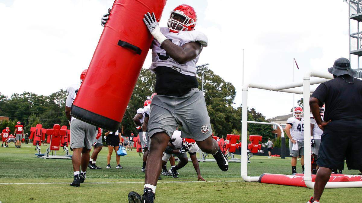 Georgia defensive lineman Julian Rochester (5) completes a drill at practice in Athens on Monday.