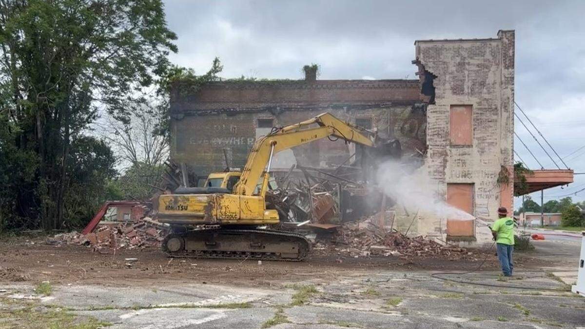 A bulldozer tears down an abandoned building located on Houston Avenue on Wednesday.