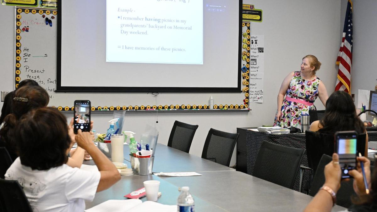 Central Georgia Technical College adult education students take a picture of a slide showing uses for the word “remember” in an English as a Second Language (ESL) course on Tuesday, May 27, 2025, at Central Georgia Technical College in Warner Robins, Georgia. Central Georgia Technical College in Warner Robins receives about $1.3 million in Adult Education and Family Literacy Act grants along with state matching funds, which could be in jeopardy with President Trump’s proposed budget reductions.