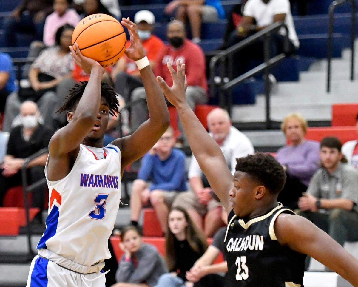 Veterans’ Jeremy Sams (3) puts up a shot over a Calhoun defender Friday night during the Warhawks’ 78-61 loss in their second round state playoff game.