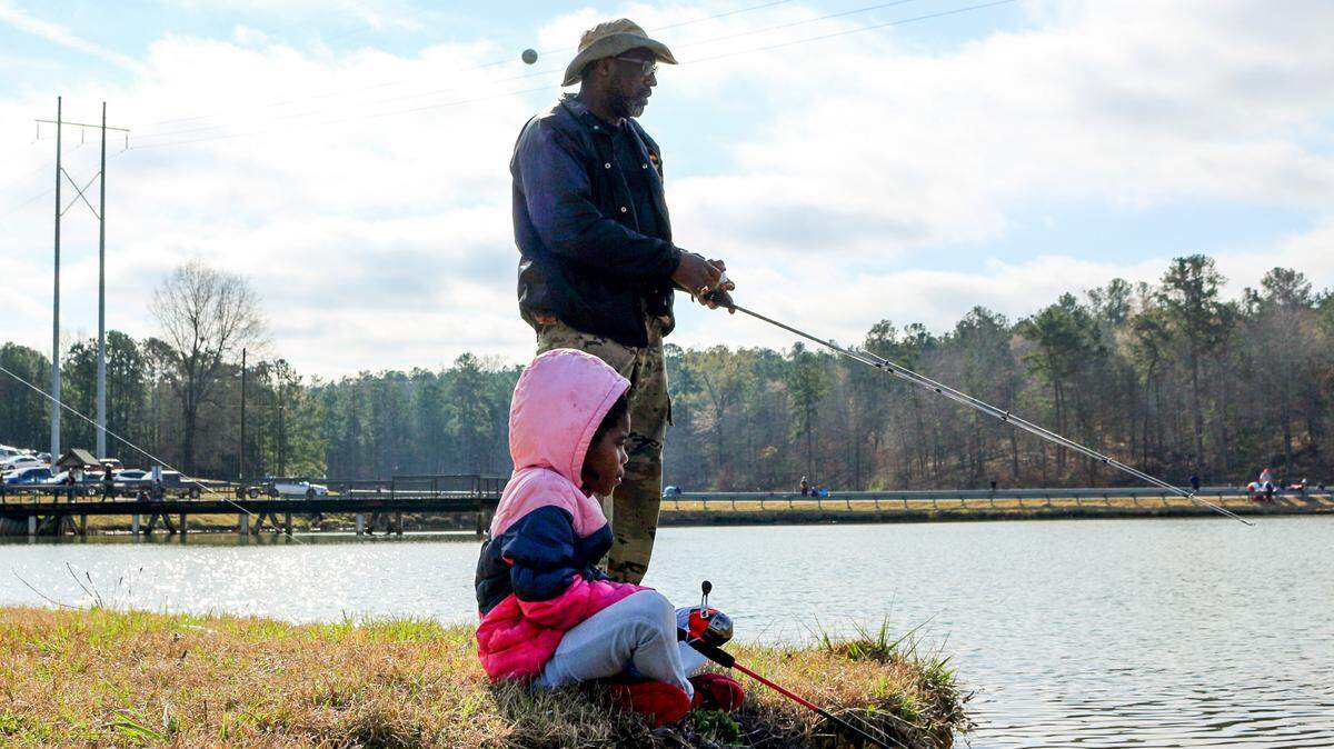 Kobi Cross and her uncle, Willie Mobley, fish during the annual Kids Fishing Derby Saturday at Javors Lucas Lake.