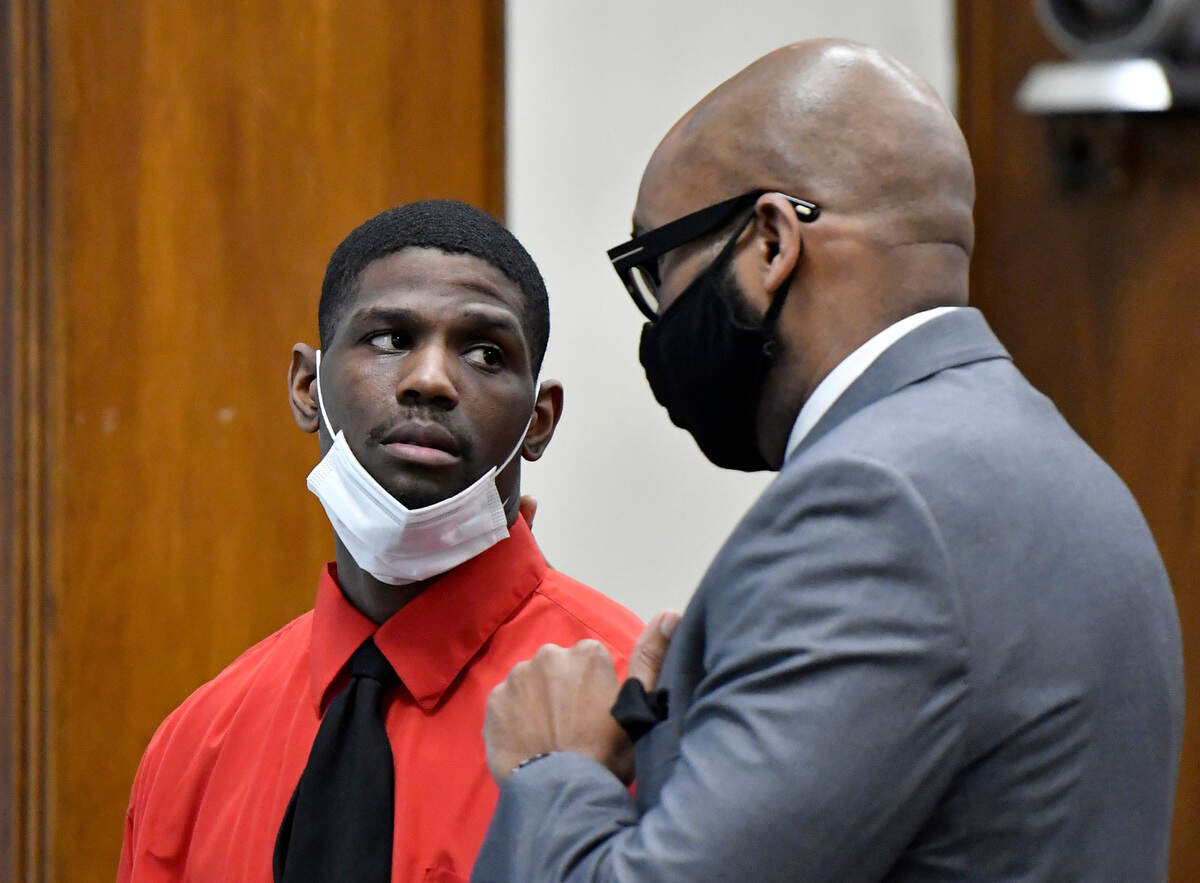 Anterrio Tremaine Stinson talking to his defense attorney Corey T. Bowles in a Bibb County courtroom on Thursday. Stinson was accused of killing and robbing Jackie Dewayne Rouse on Halloween night in 2017.