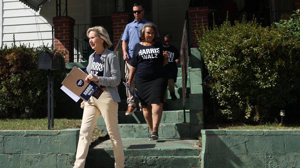 Gwen Walz, First Lady of Minnesota and wife of Democratic vice presidential candidate Tim Walz, walks off the porch of a Pleasant Hill house while canvassing with Georgia House representative Miriam Paris (right) on Thursday, Oct. 31, 2024, in Macon, Georgia. Walz stopped in Macon on a campaign trip through Georgia supporting the Harris Walz campaign one day before the last day of early voting.