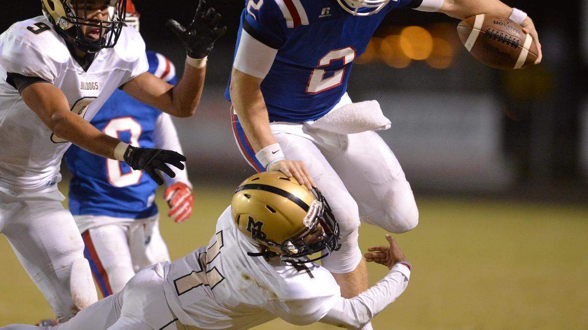 Veterans quarterback Logan Byrd gets brought down by Mary Persons defender Bruce McCall in first half action Friday night in Perry.
