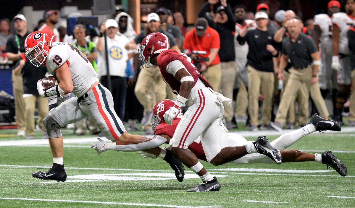 Georgia tight end Brock Bowers (19) breaks a tackle on his way to the end zone for a touchdown during the Bulldogs’ 41-24 loss to Alabama Saturday in the SEC Championship.