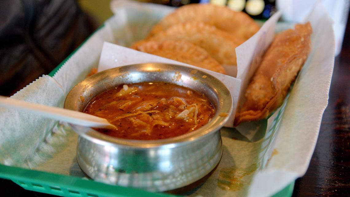 JENNA EASON/THE TELEGRAPH Macon, GA, 12/31/2019: Reporter Justin Baxley ordered stewed chicken soup at My Grandma’s Empanadas along with four empanadas for this week’s episode of #FoodieFriday.