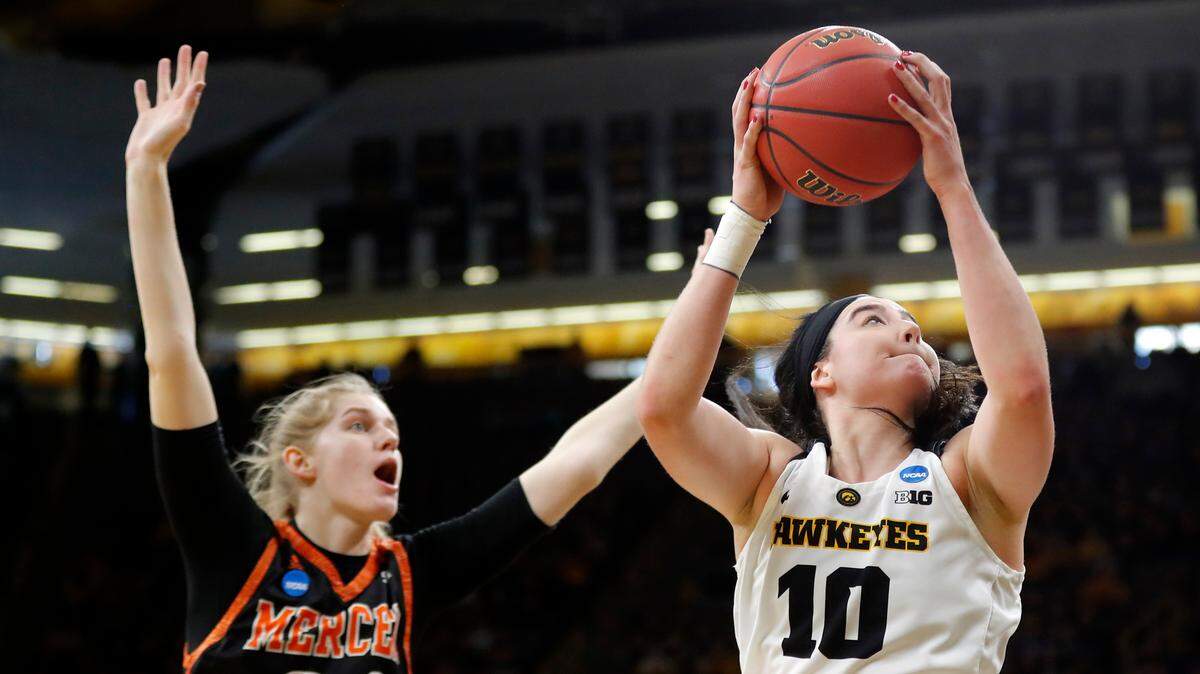 Iowa forward Megan Gustafson drives to the basket past Mercer center Rachel Selph, left, during a first-round game in the NCAA women’s college basketball tournament, Friday, March 22, 2019, in Iowa City, Iowa.