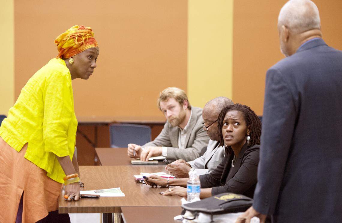 Macon Charter Academy founder Monya Rutland, left, speaks with members of the school board after a meeting Tuesday night.