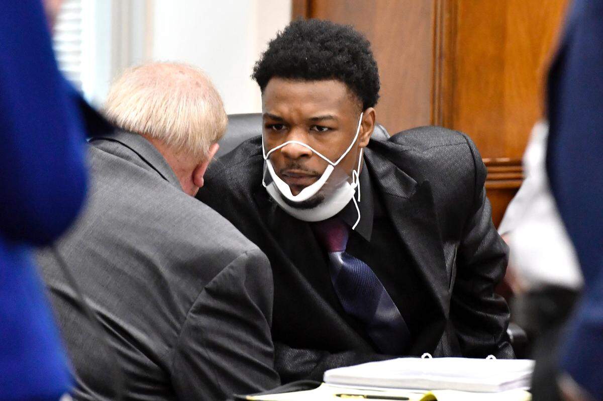 Dequavious Howard, right, confers with his attorney Stanley W. Schoolcraft III during the first day of testimony in Howard’s murder trial on Wednesday in Bibb County Superior Court.