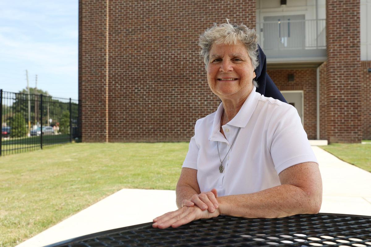 Depaul USA Macon director Sister Theresa Sullivan poses while sitting at a picnic table between the Sheridan Health Center and Daybreak on Tuesday, Sept. 12, 2024, in Macon, Georgia. Sullivan is a member of the Daughters of Charity, a Catholic religious order whose mission is to serve the poor and those in need. Sullivan has served as the director of homeless resource center Daybreak for the past eight years and will begin a new position in Detroit in October.