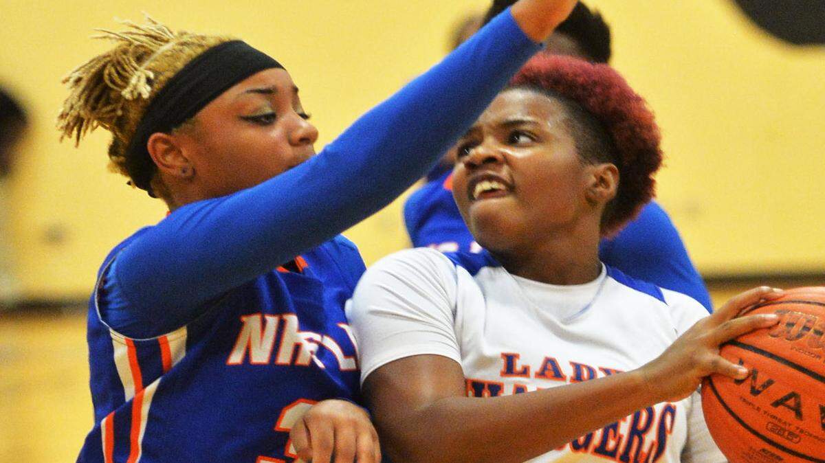 Northside's Jaliyah Lynch (32) blocks a drive up the lane by Central's Renesha Goolsby (4) during their game Friday at Central.