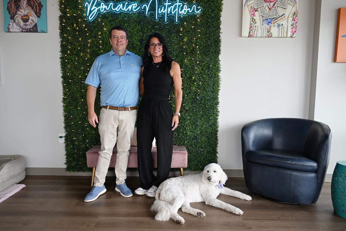 Bonaire Nutrition owners Kent Jordan and Laura Waters pose with their dog Daffy inside of their store in Warner Robins, Georgia. The new shop specializes in dietary-supplement drinks, including loaded teas, protein coffees and meal replacement shakes.
