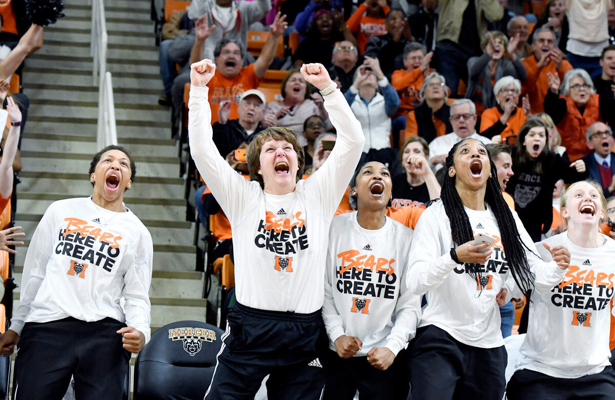Mercer head coach Susie Gardner and members of the team jump off their seats after it was announced the Bears will play at Georgia during the first round of the NCAA Tournament.
