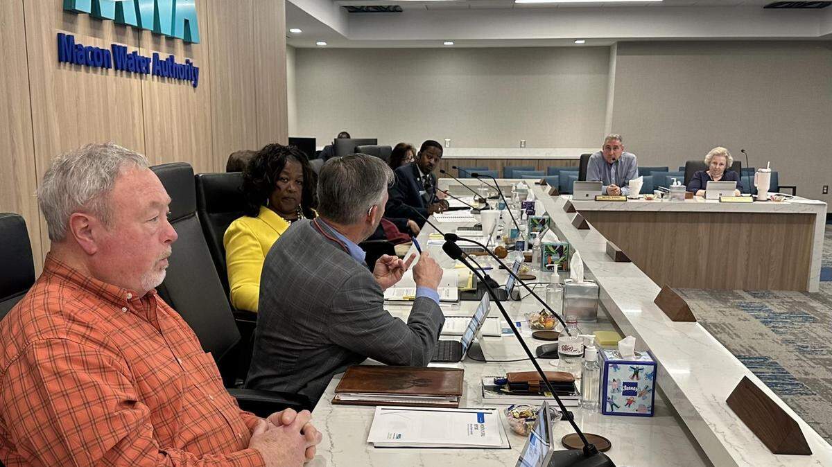 Macon Water Authority Finance Chairman Dwight Jones, center left, discusses purchasing card issues with District 2’s Desmond Brown during the March 6 MWA meeting.
