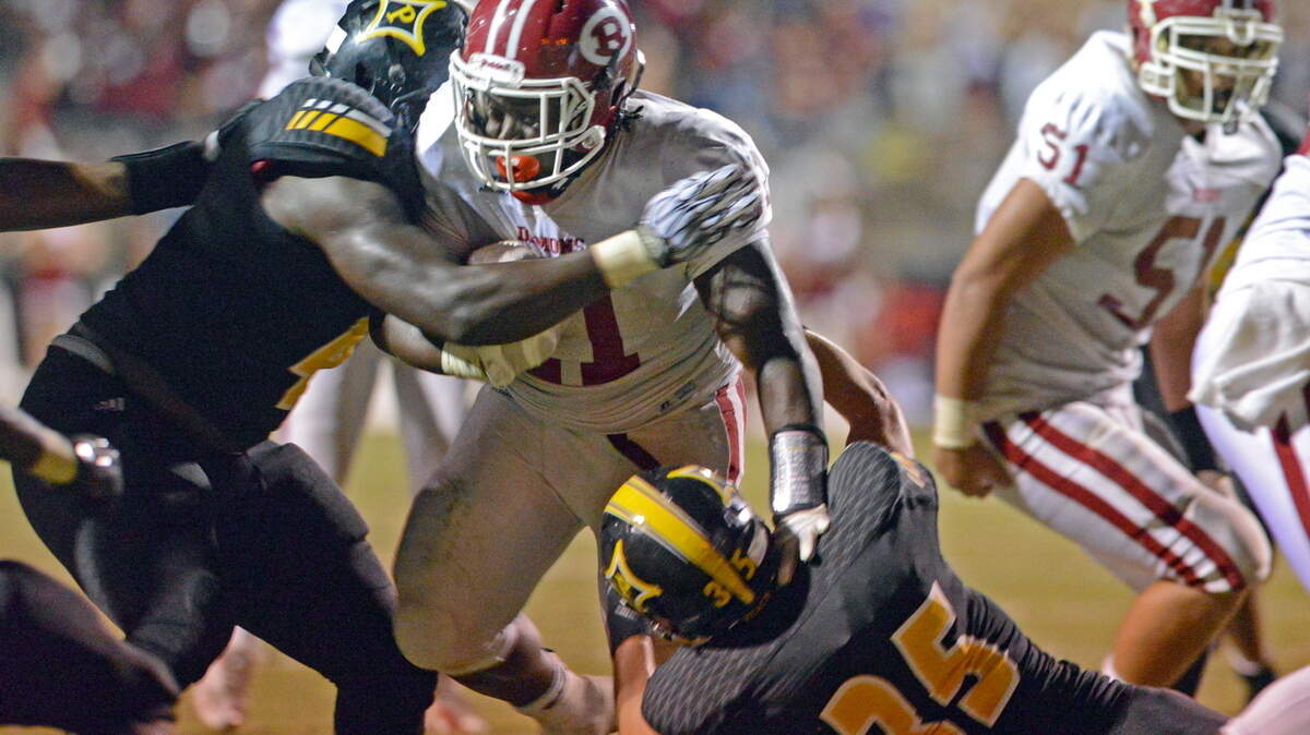 Warner Robins Running Back Terry Harris is met near the goal line by Peach County's Tim Deese and a flock of Peach defenders. Photo by Danny Gilleland For The Telegraph 08/28/15 Fort Valley, Ga