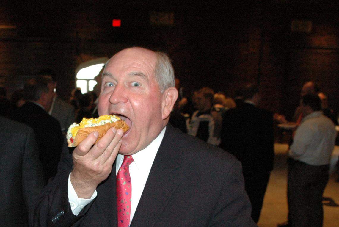 Former Georgia Gov. Sonny Perdue vamps for the camera a bit as he bites into a Nu-Way hot dog at Macon Day at the state capitol during his final term more than a decade ago. The governor’s hot dog toppings were slaw, mustard and a little bit of chili.