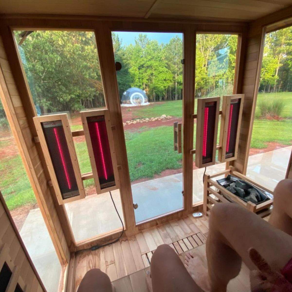 Guests enjoy a view of the peaceful outdoors while relaxing in an infra-red sauna at The Florrest in Hillsboro, GA.
