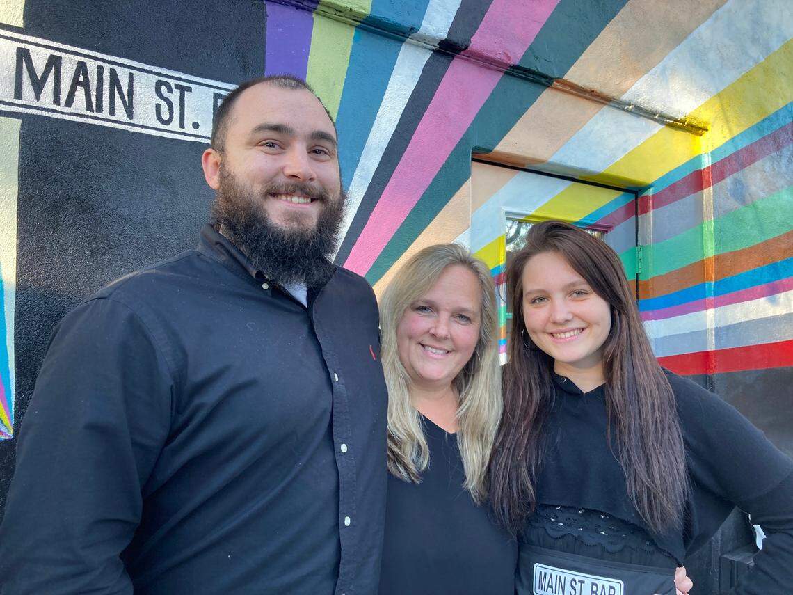 Shannon Stricklen, center, with son, Zach Bibbins, and daughter, Jamie Stricklen, at Main St. Bar, an upscale, family owned and operated bar that celebrates its grand opening Friday.