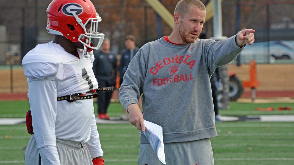 Georgia inside linebackers coach Glenn Schumann talks to Georgia inside linebacker Roquan Smith (3) during the Bulldogs’ practice at Rhodes College in Memphis, Tenn., on Tuesday, Dec. 27, 2016. (Photo by Steven Colquitt)