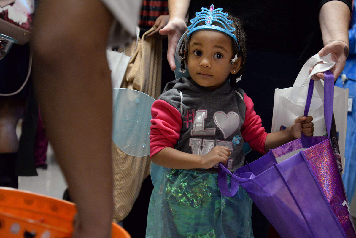 Jasmine Richardson, 3, walks down the hall at the Beverly Knight Olson Children’s Hospital to collect candy at their annual trick-or-treat event.