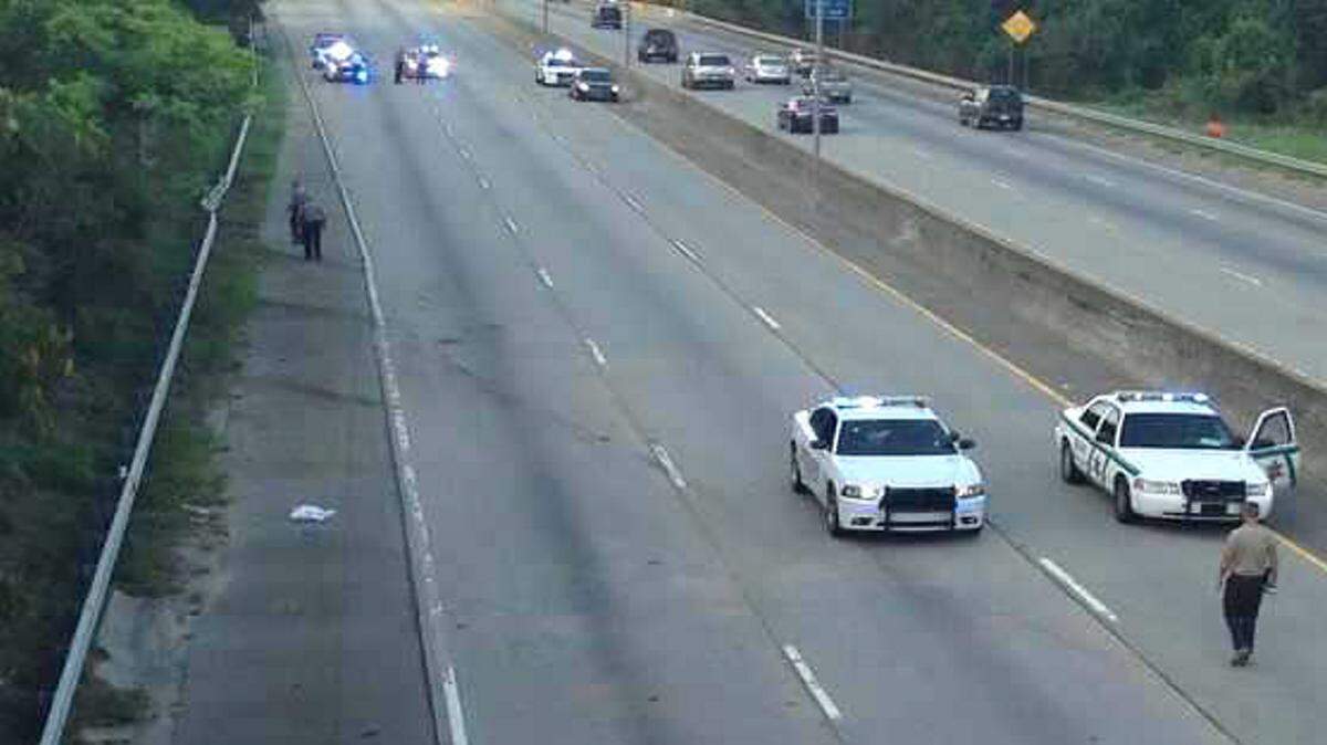 Bibb deputies look for evidence after an Aug. 9 accident on Interstate 75 South. Edward Boland suffered a fatal injury when he was ejected from his SUV as he hit the guardrail just past the Hardeman Avenue exit.