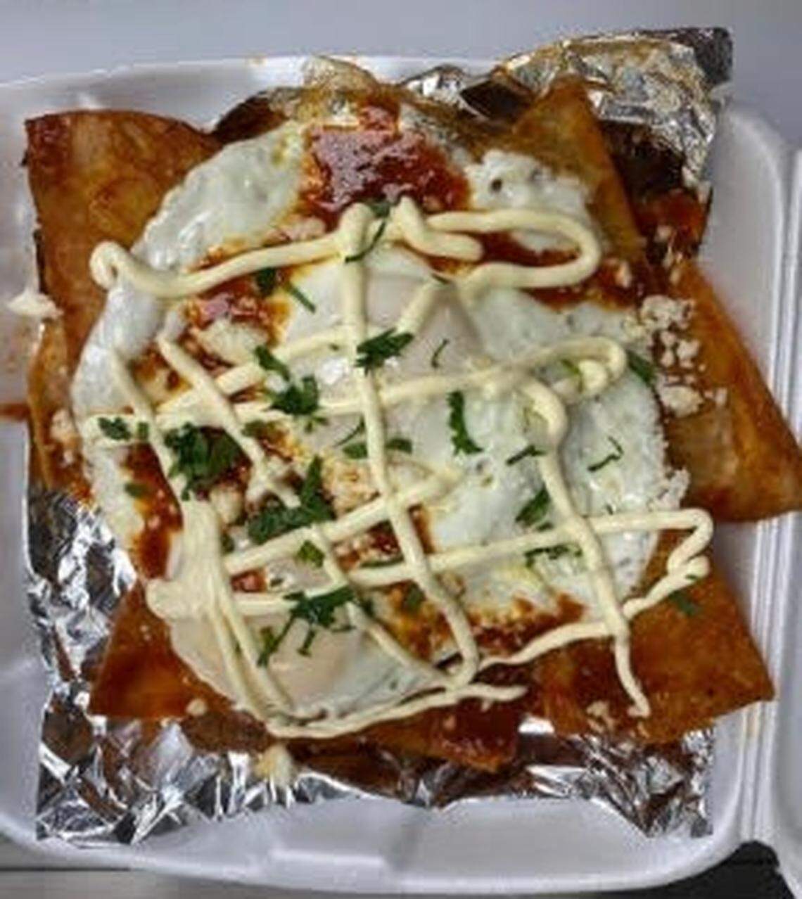 Breakfast chilaquiles with chips, red salsa, sour cream, cilantro and egg at El Ranchito in Warner Robins.