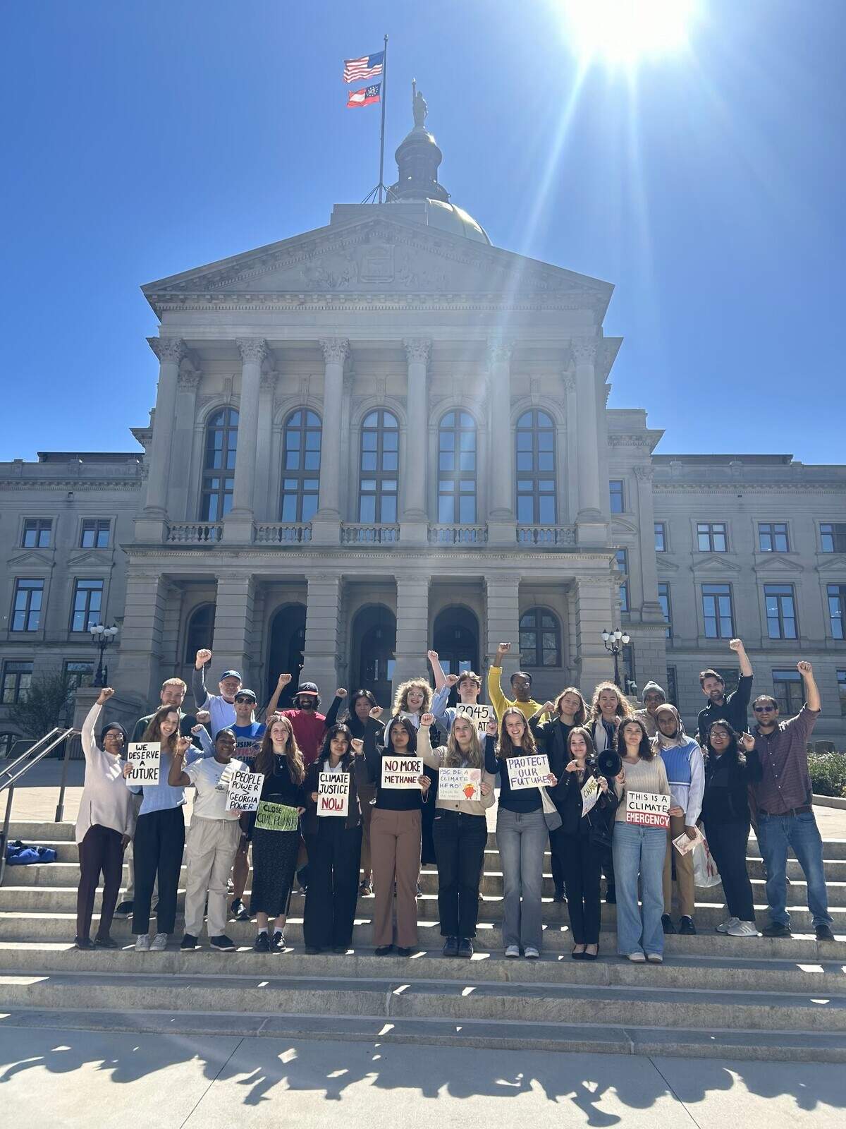 Emory students joined by other civilians, some who also testified, rallying outside the capital after speaking at the PSC hearing