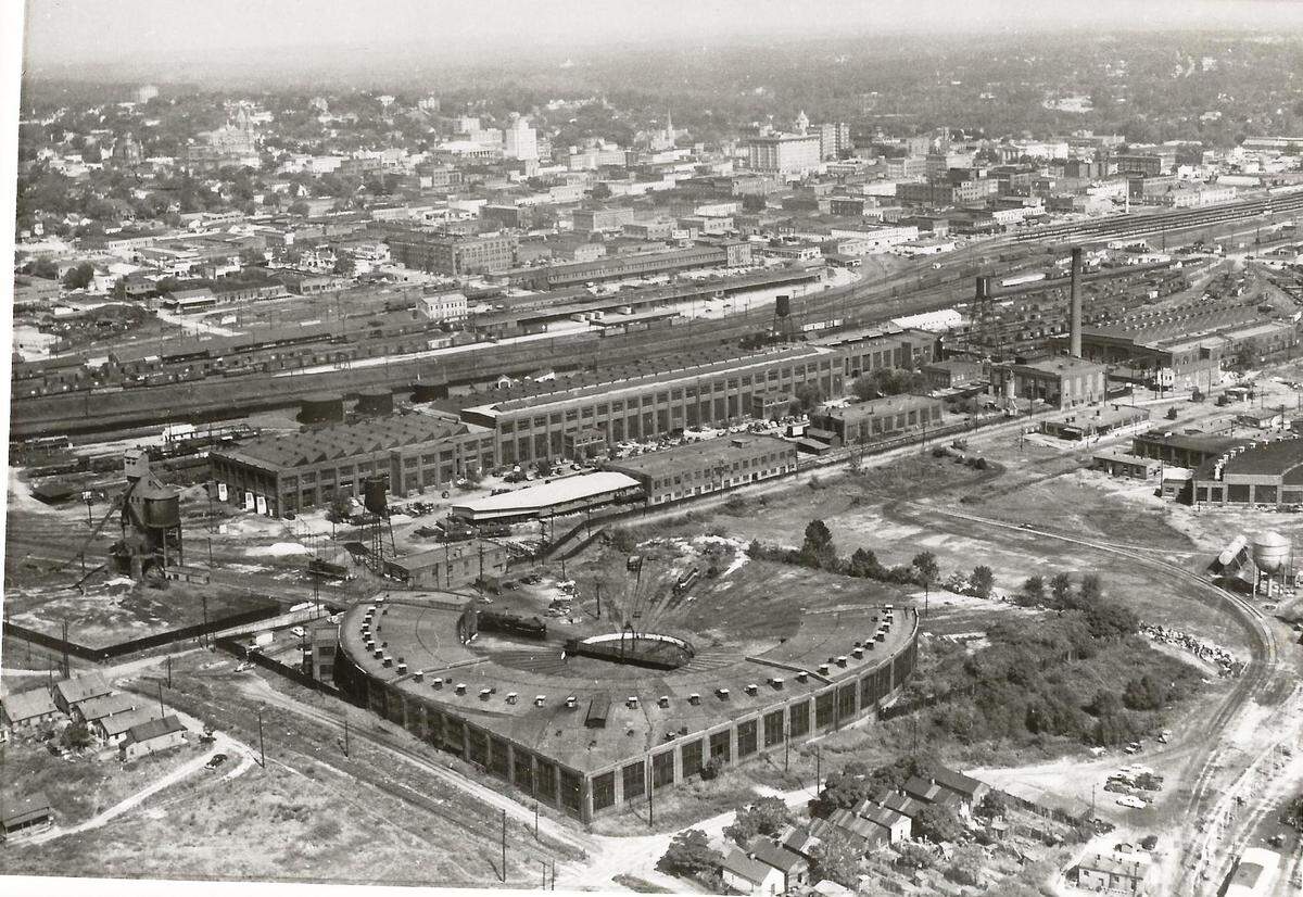 An aerial view of the Central of Georgia Railway railroad repair shops and roundhouse complex with the Coal Tower pictured on the left taken in 1957.