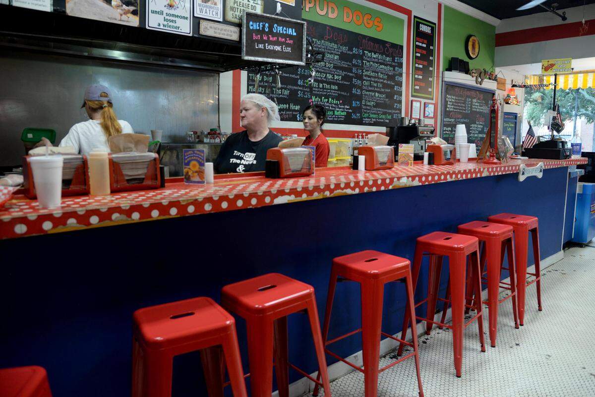 Spud Dogs employees work to get food ready for customers on Tuesday, Oct. 15, 2019.