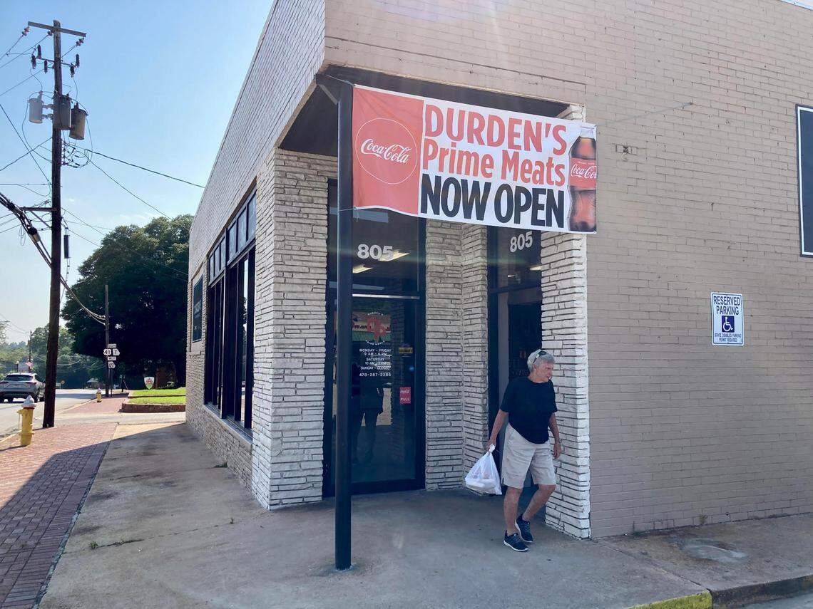 A customer exits the store at Durden’s Prime Meats in downtown Perry.