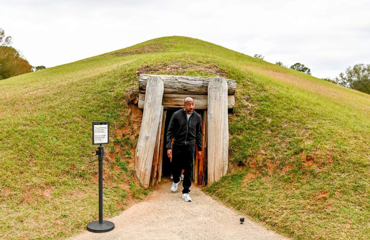Sen. Warnock emerges from the Earth Lodge.