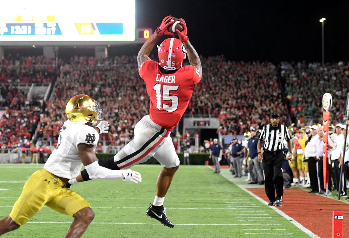 Georgia receiver Lawrence Cager (15) hauls in a touchdown pass during the Bulldogs’ 23-17 win Saturday night in Athens.